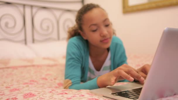 Young girl typing on her laptop — Stock Video