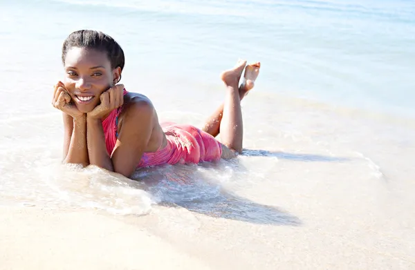 Woman laying on sea shore — Stock Photo, Image