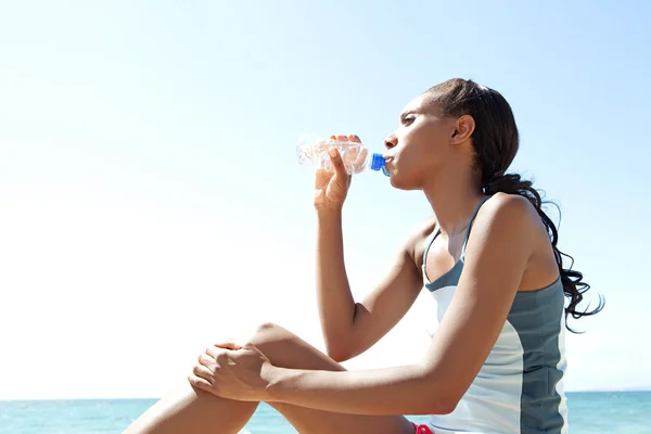 Woman drinking mineral water — Stock Photo, Image