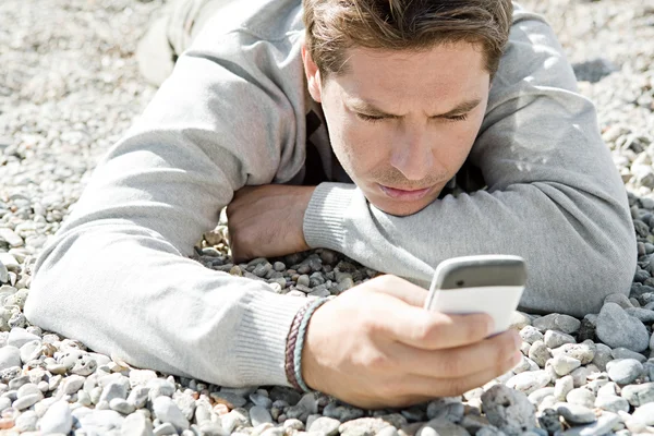 Man sitter på stranden — Stockfoto