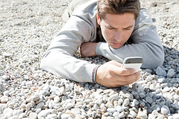 Man sitting down on the shore — Stock Photo, Image