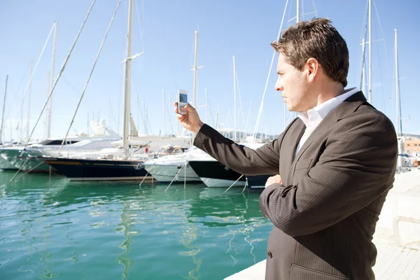 Businessman taking pictures with his smart phone — Stock Photo, Image