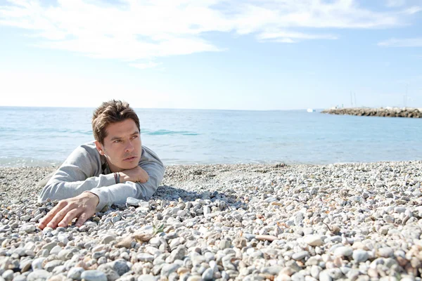 Man sitting down on the shore — Stock Photo, Image