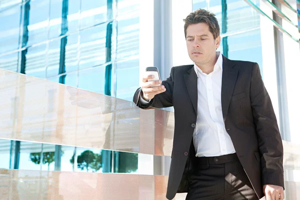 Professional business man holding a smart phone — Stock Photo, Image