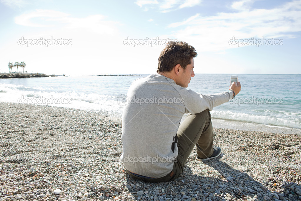 Man sitting down on the shore