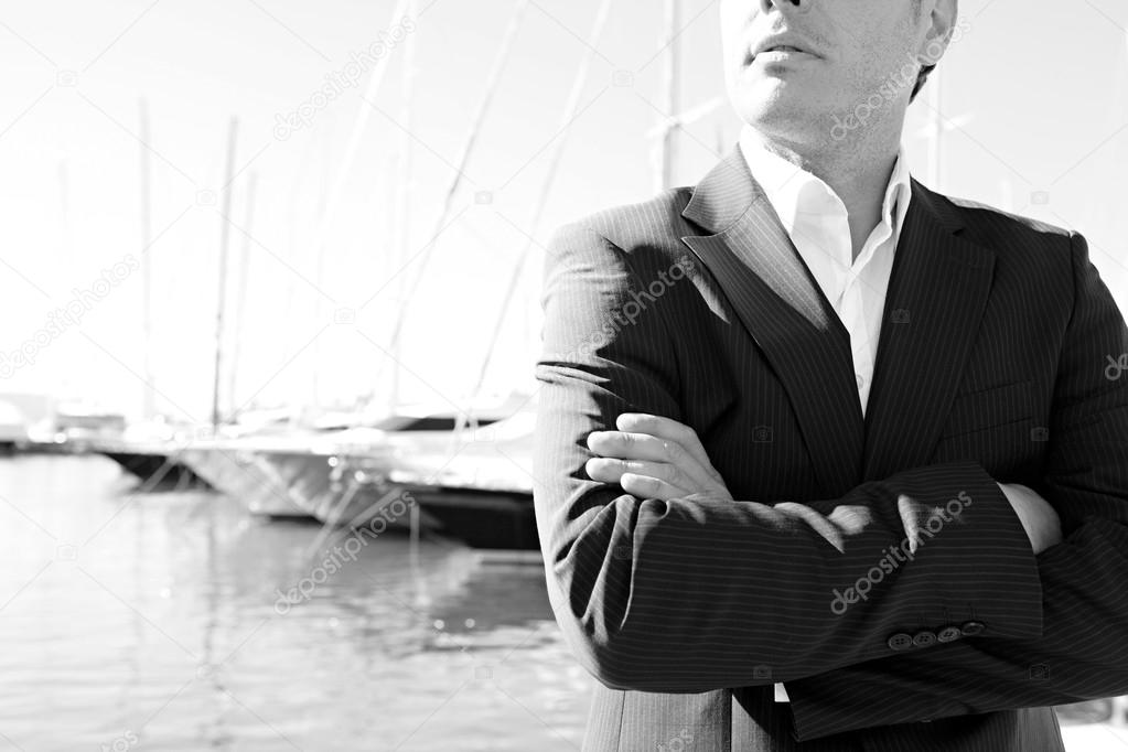 Businessman standing by a luxury yachts