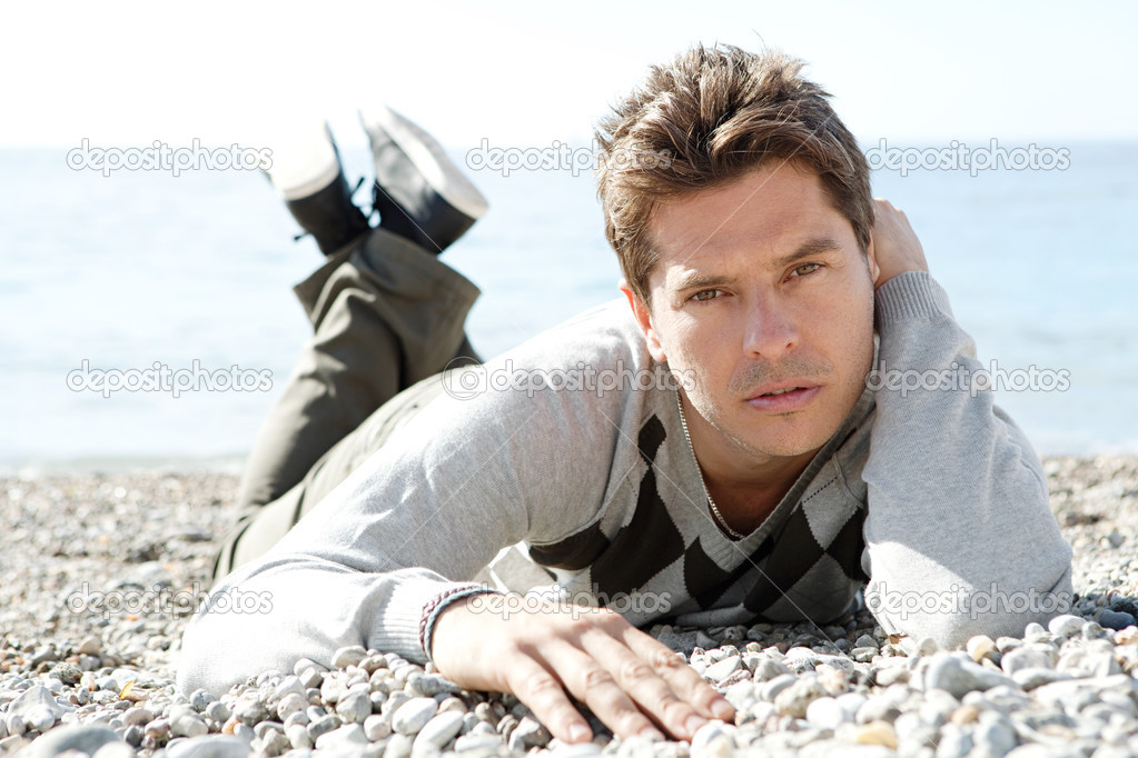 Man sitting down on the shore