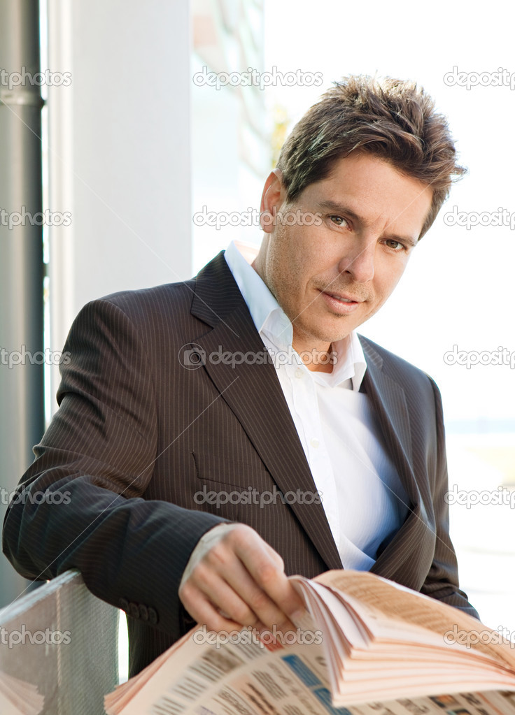 Business man holding a financial newspaper