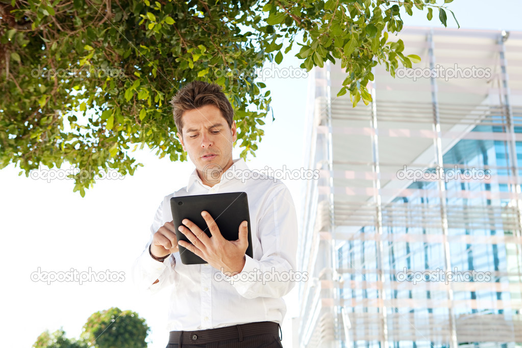 Successful businessman using a digital tablet