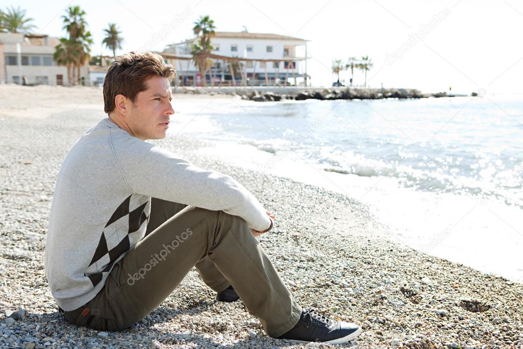 Man sitting down on the shore