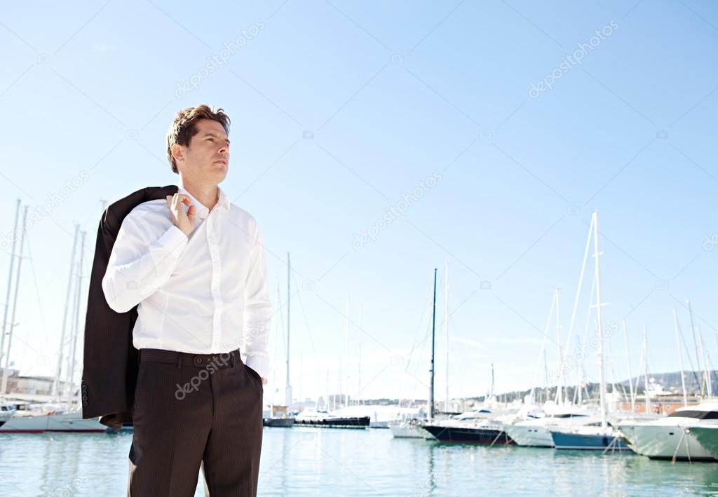 Businessman standing by luxury boats