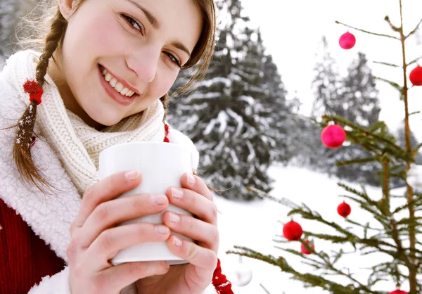 Woman holding a hot cup — Stock Photo, Image