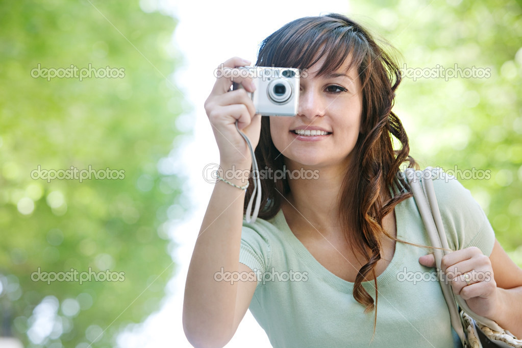 Woman using photographic camera