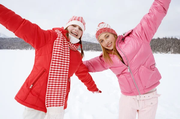 Two girls playing games and having fun in in winter — Stock Photo, Image