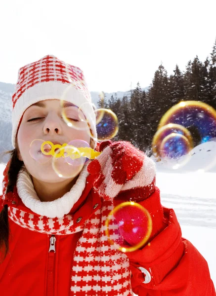 Woman blowing soap bubbles outdoors — Stock Photo, Image