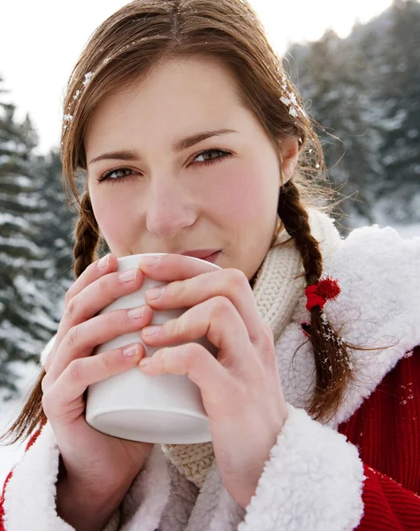 Woman holding a hot cup — Stock Photo, Image