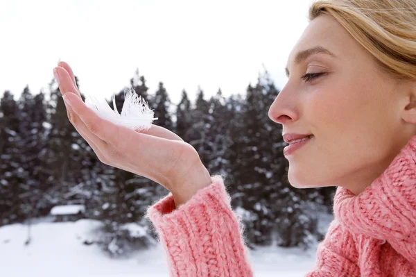 Woman holding feather — Stock Photo, Image