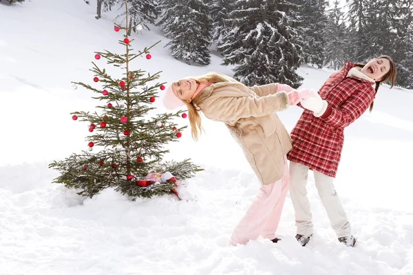 Meisjes rond de kerstboom — Stockfoto