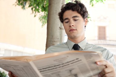 işadamı bir Finansal gazete okuyor