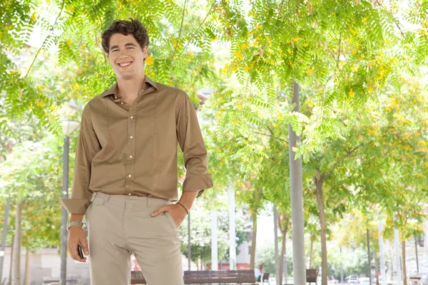 Businessman standing in a city park — Stock Photo, Image