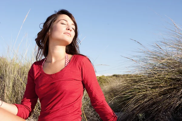 Woman   sitting on a beach — Stock Photo, Image