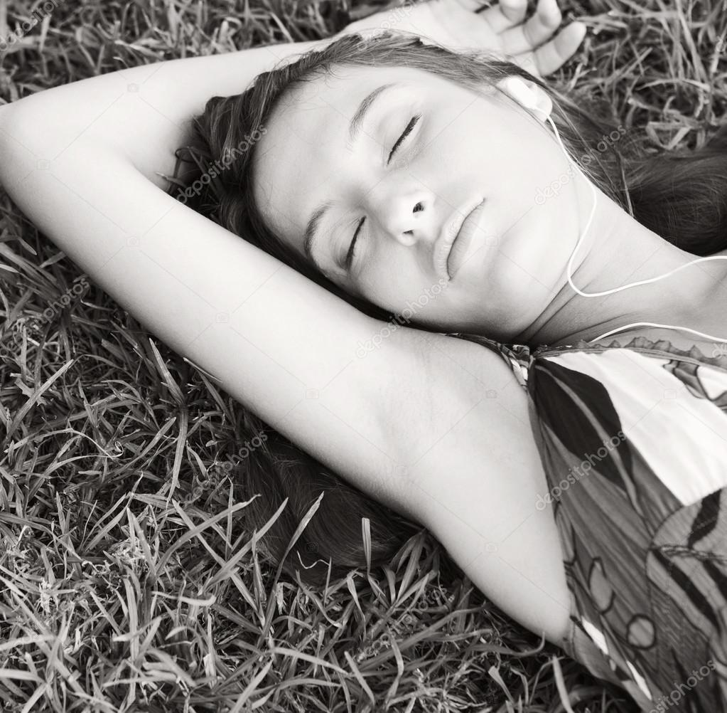 Woman laying on textured green grass