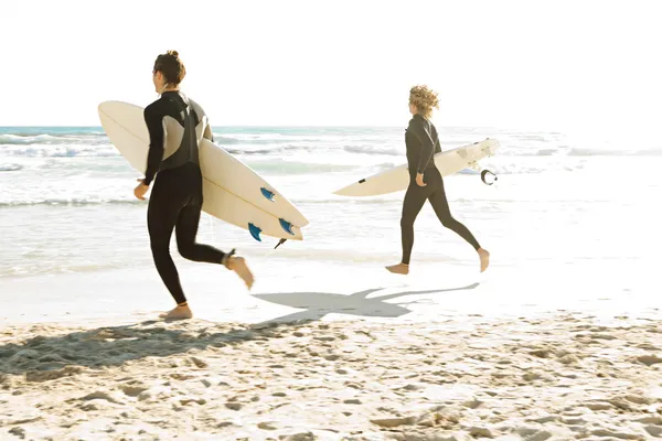 Surfers running together — Stock Photo, Image