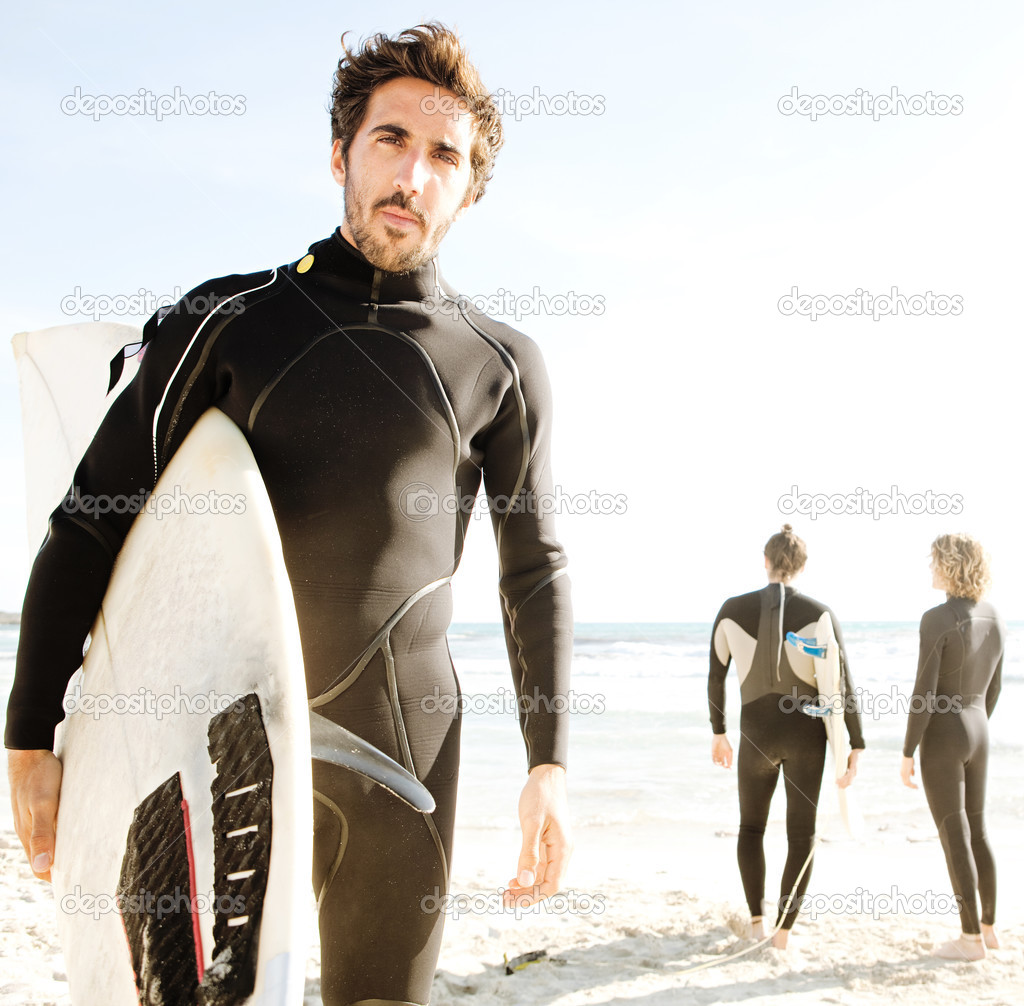 Surfer friends standing together