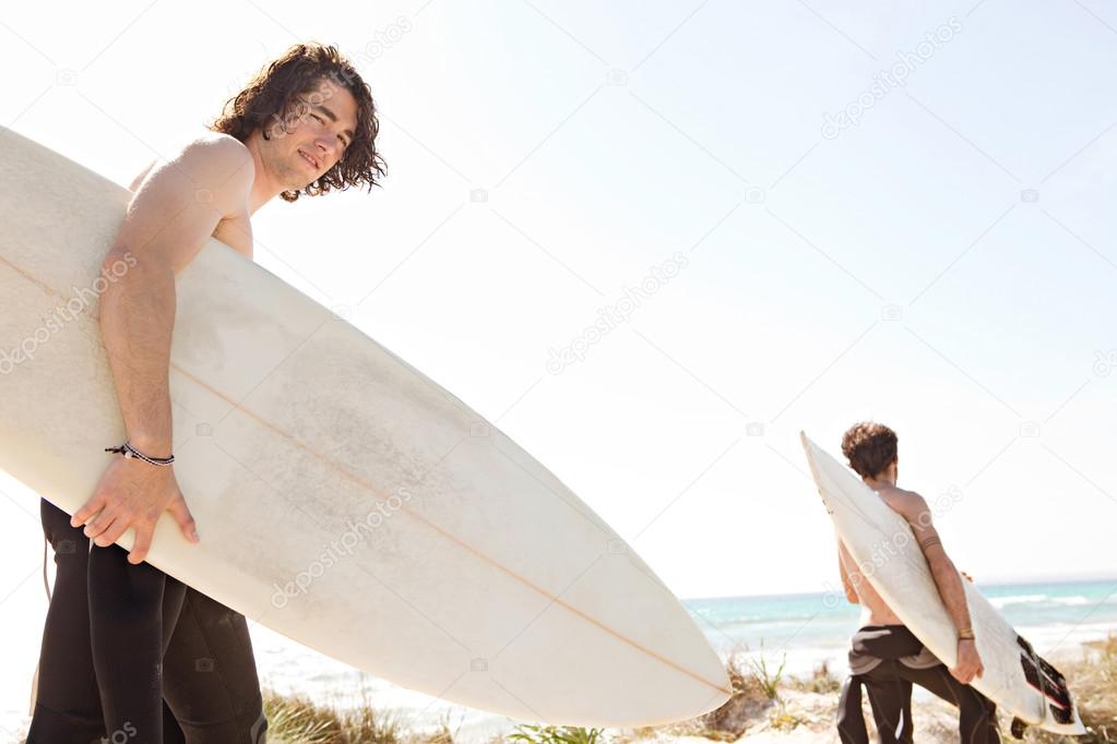 Surfer friends walking