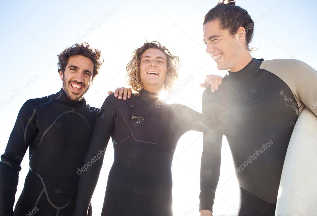 Surfers friends laughing