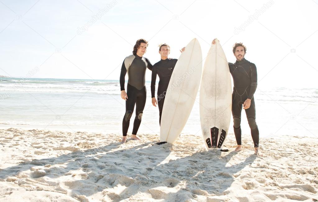 Surfers men standing