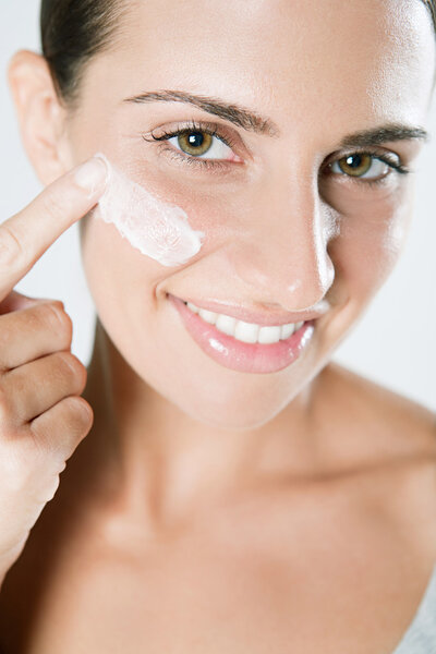 Woman applying  care cream