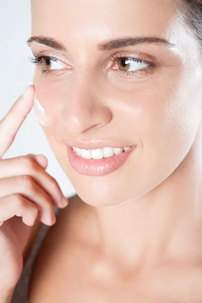 Mujer aplicando crema de cuidado — Foto de Stock