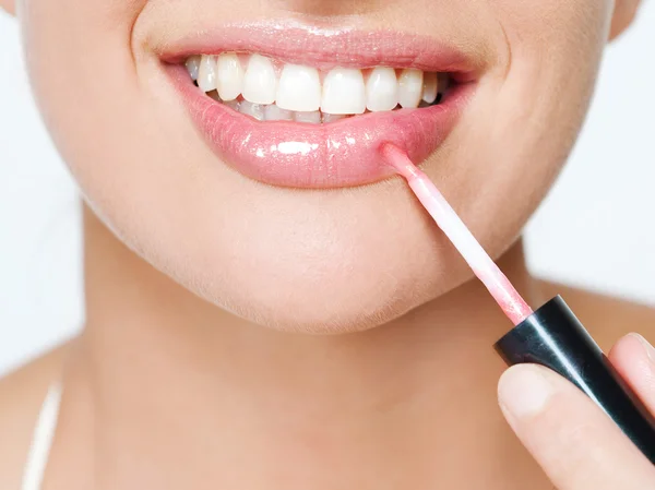Woman applying pink  lipstick — Stock Photo, Image