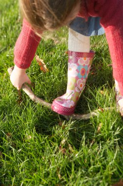 Girl trying  break branch clipart