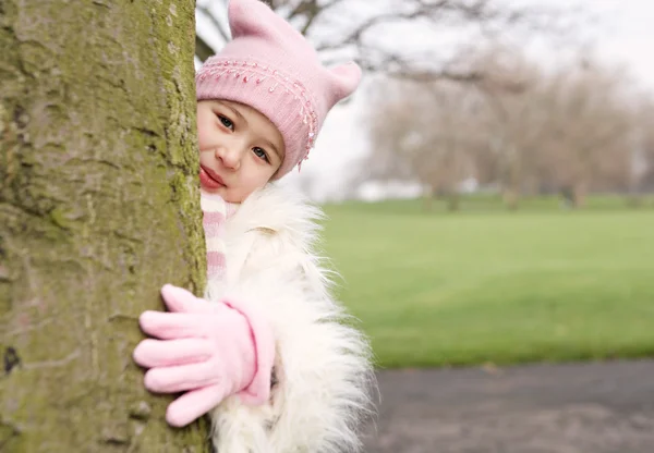 Girl playing and hiding — Stock Photo, Image