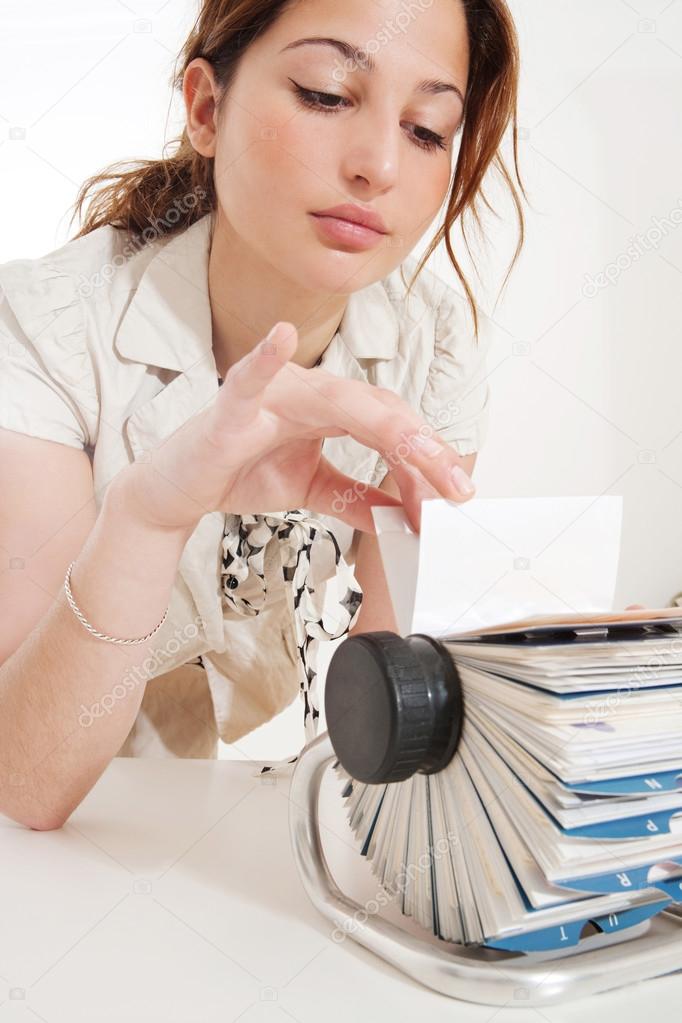 Businesswoman flicking clients files