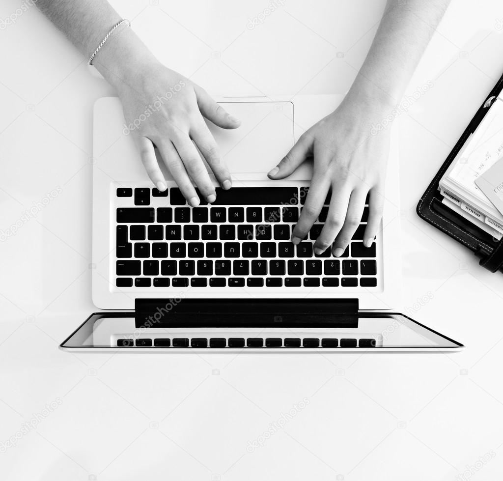 Woman hands typing  on laptop