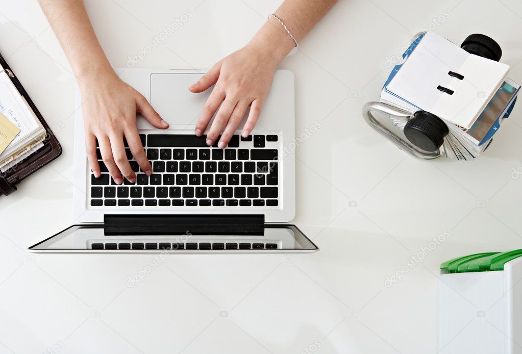 Woman hands typing  on laptop