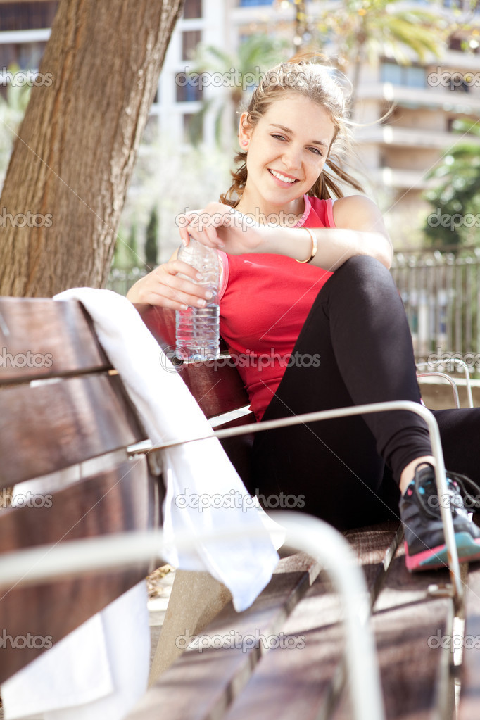 Young sports woman sitting