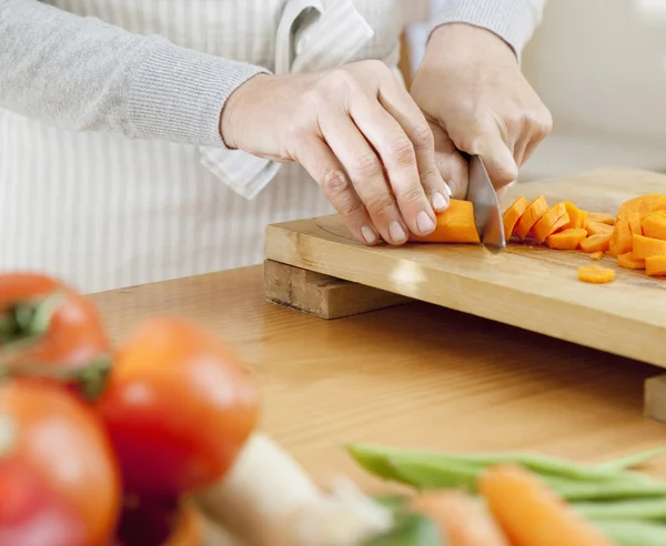 Mujer rebanando zanahorias — Foto de Stock