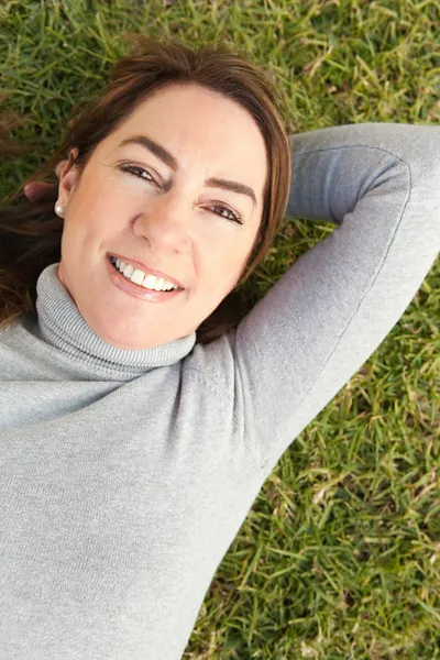 Laying down on green grass — Stock Photo, Image