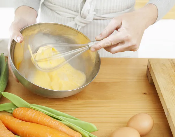 Womans hands beating eggs — Stock Photo, Image