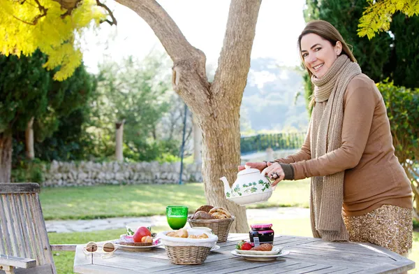 Woman pouring and serving tea