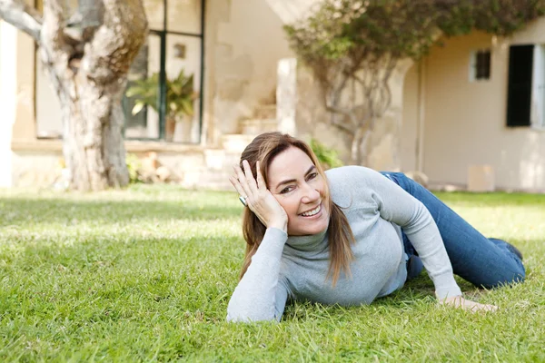 Laying down on green grass — Stock Photo, Image