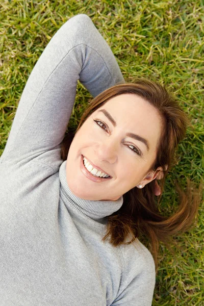 Laying down on green grass — Stock Photo, Image