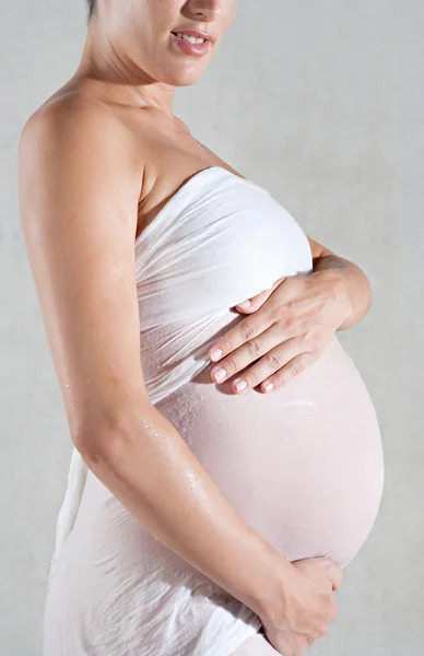 Faceless pregnant woman holding her belly — Stock Photo, Image