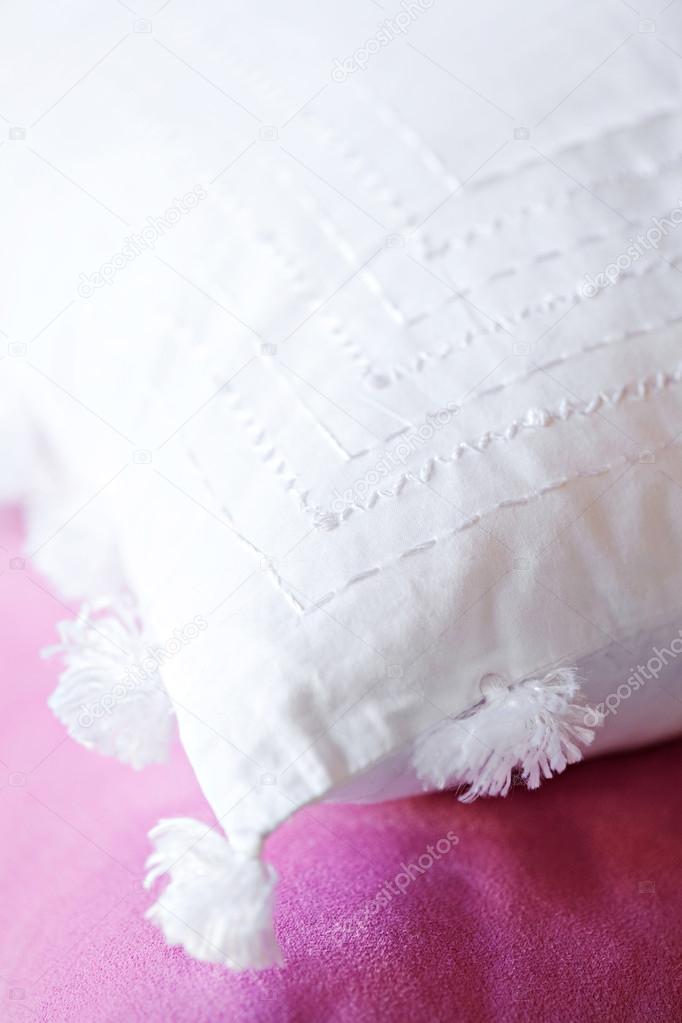 Embroidered white cushion