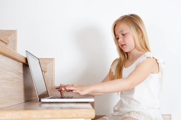 Young girl child using a laptop computer