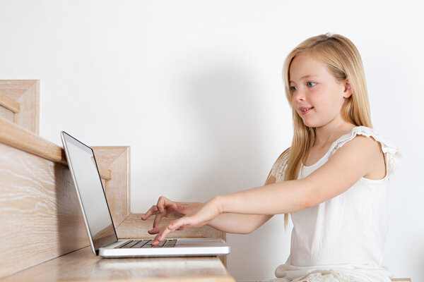 Young girl child using a laptop computer